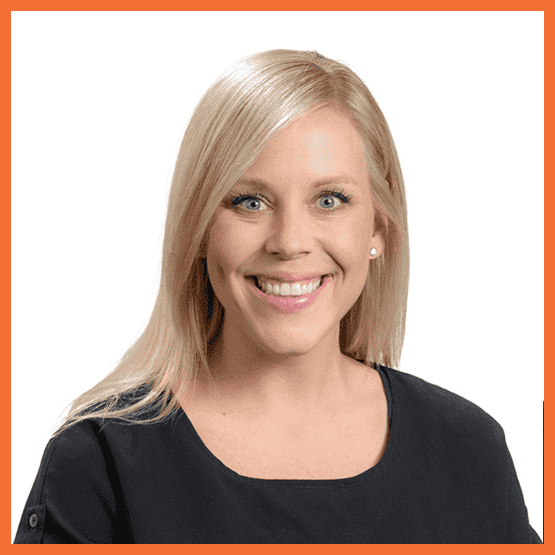 Head-and-shoulders portrait of a smiling blonde woman in a black top against a white background.