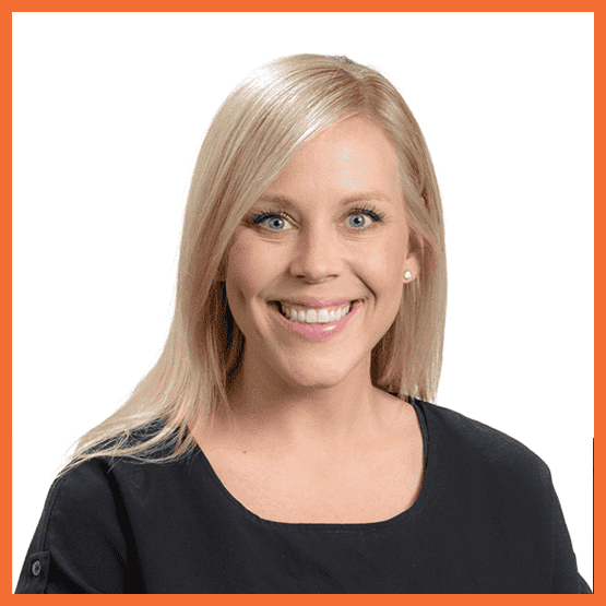 Portrait of a smiling blonde woman in a black top against a white background.