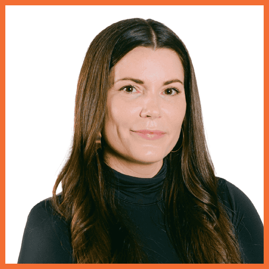 Portrait of a woman with long dark hair in a black turtleneck, facing the camera with a gentle smile.